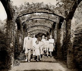 Driven from their home by the Nazi war machine, Prince Felix of Luxembourg and his six children are shown in the garden of their U