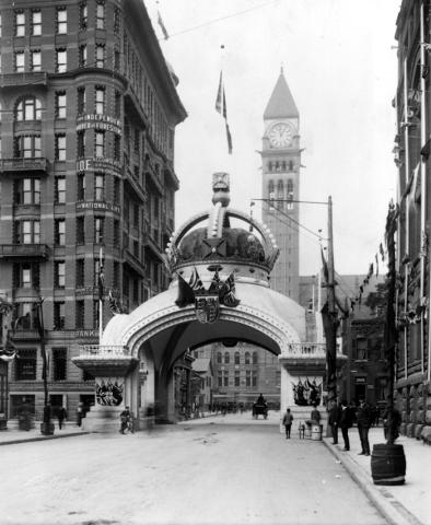 Bay Street looking north from below Richmond Street West, showing arch built by Independent Order of Foresters for visit to Toronto of Duke and Duchess of Cornwall and York (Later George V)
