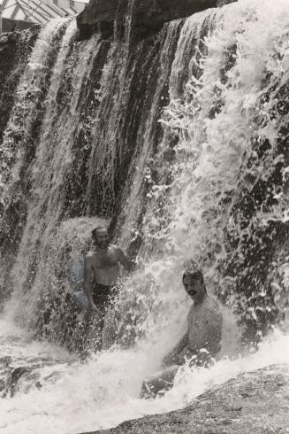 Terry Robinson and Glen Martin pause to get refreshed under the 20-foot waterfall. Acton, Ontario