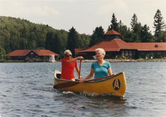 Arowhon Pines, Eugene and Helen Kates canoeing on Little Joe Lake. Algonquin Pronvcial Park, Ontario