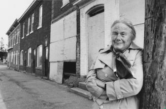 Phyllis Davey standing on main street, Alton, Ontario
