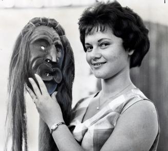 Loretta Delduca with a medicine man's mask. Chippewa, Ontario