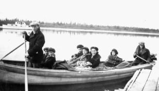 Minister and children in canoe