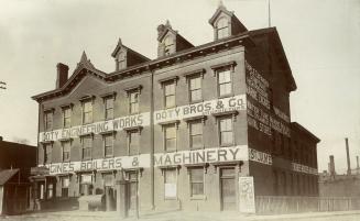 Image shows a three storey building with a few signs that read: " Doty Engineering Work Doty Br ...