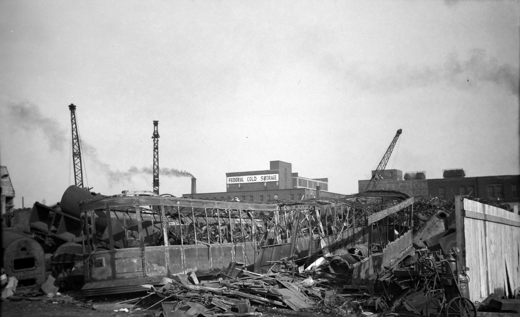 T.T.C., #2968 (at left), burnt for scrap at Western Iron & Metal Co., Mill St., showing car #2934 at right