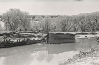Image shows a river view with some trees on one side.