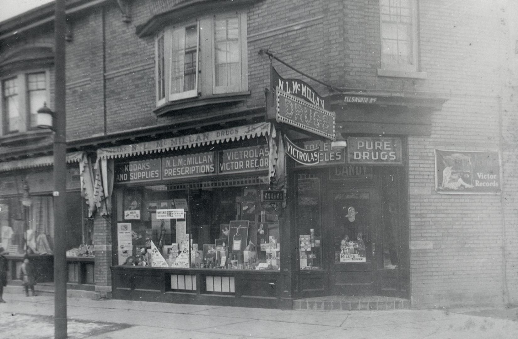 Image shows the front windows of the drug store that is located on the ground floor of a two st…