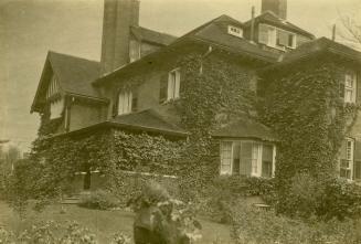 Image shows a three storey house on the hill.