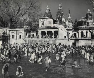 Hindus bathe in the holy water of the Ganges at Varanasi, India