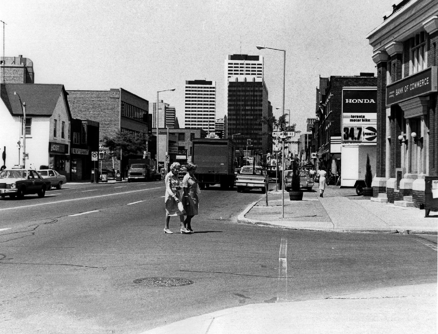 Yonge Street looking north from Millwood Road, Toronto, Ontario. Image shows a few people cross ...