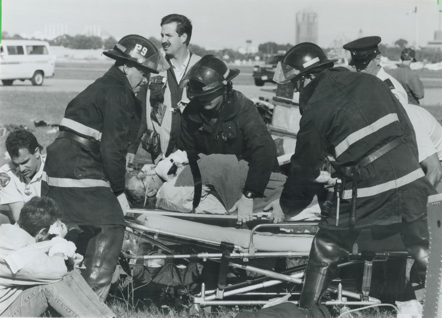 Just testing. Fire and ambulance crews attend to victims yesterday after a mock plane crash at the Toronto Island Airport. In the simulated disaster, (...)