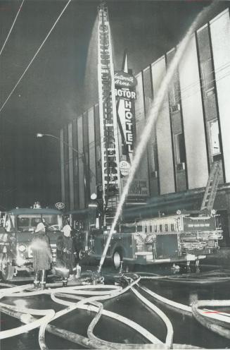 A hose plays on the Wentworth Arms Hotel in downtown Hamilton during a fire Christmas night in which at least six people were killed. A 26-year-old ma(...)