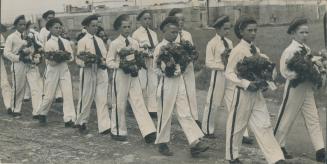 Carrying funeral wreaths, boys in white uniforms, shown here, led the solemn procession down the main street of the gold mining town of Malartic as th(...)