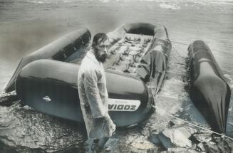 Marked by tragedy, co-pilot Dick Overgaard of New Mexico stands by damaged raft that buckled during experimental run in Niagara River rapids, throwing(...)