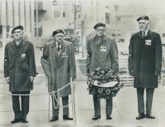 Four war veterans, who remember sacrifices of their comrades very clearly still, though the years have passed, stand at Toronto's Cenotaph yesterday, (...)