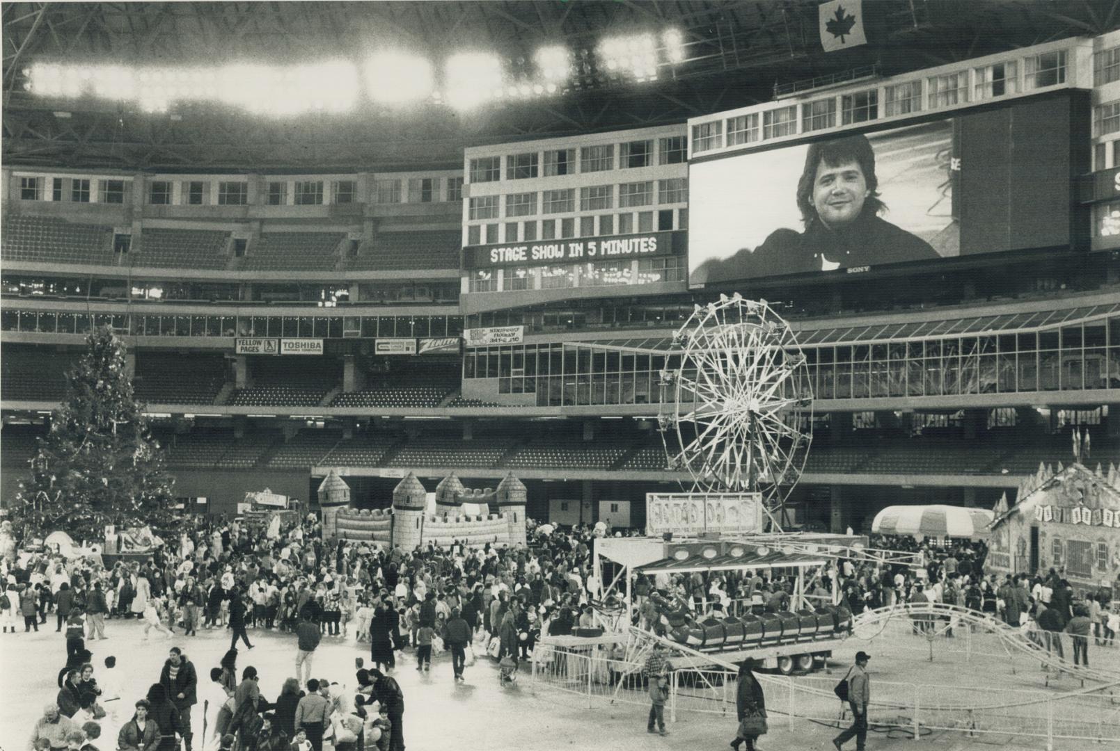 Giant party: A Ferris wheel and other rides turn the SkyDome stadium into an amusement park for the first time at a children's Christmas party