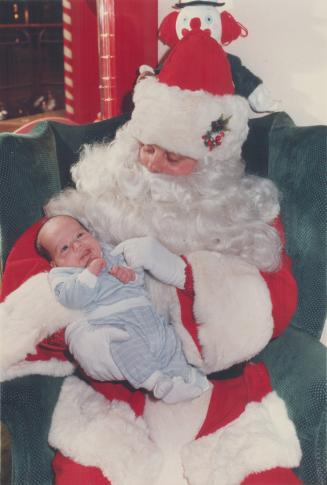 Three faces of Christmas. It's either something Santa said or Carling Thompson (8 months), left, doesn't quite like St. Nick's advice at Santa's Castl(...)