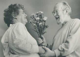 Douglas Burke, offering his wife Bettle a handful of carnations, knows that flowers, truffles and perfume make scents as gifts from the heart on St. Valentine's Day