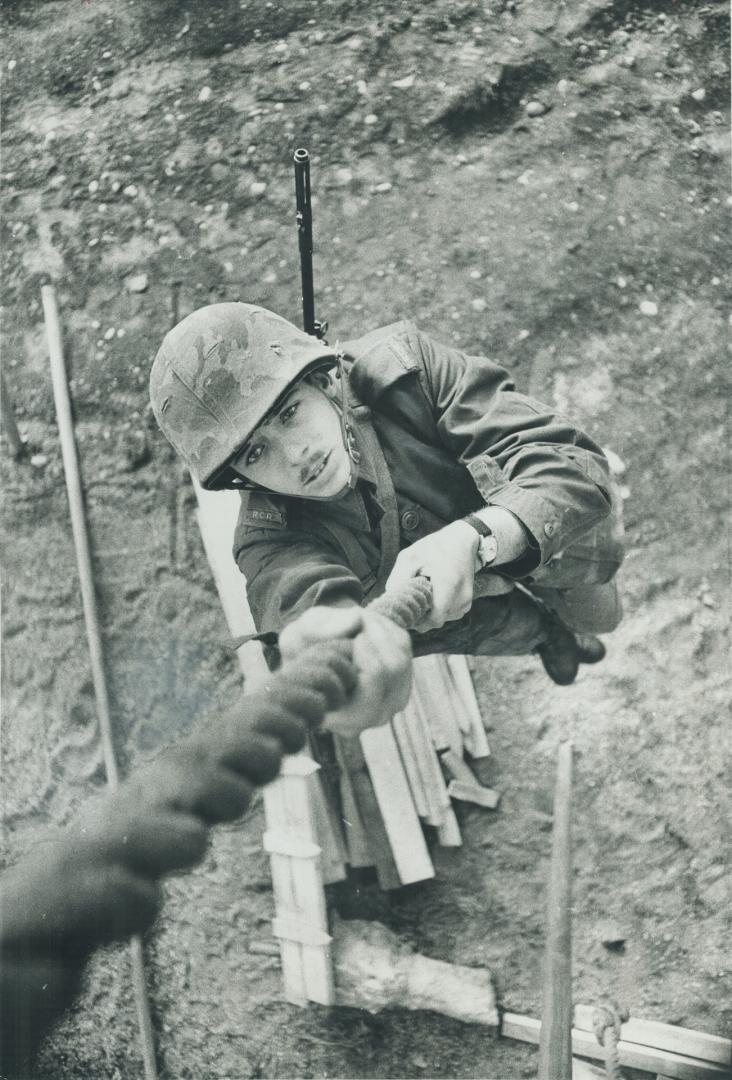 With full kit, Pte. James A. Rowe scales a 30-foot rope at Wolseley Barracks in London, Ont. where he's stationed. In the new army, sloppy drill means(...)