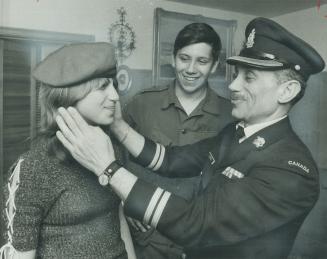 A 13-year-old girl who wants to join the cadets, Barri Denby tries on the beret of her brother, cadet CWO Kevin Denby, 16, helped by father, Capt. Edw(...)