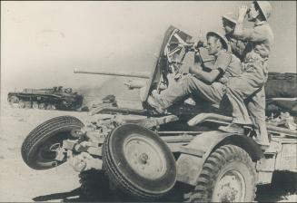 These British anti-tank gunners on the African battle front have just eliminated one more Nazi tank, and are preparing to move in for further action a(...)