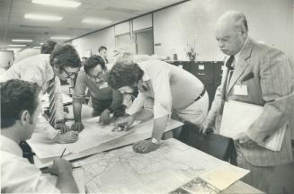 Disaster! Hydro officials study map of the region around the Bruce nuclear station, where a simulated emergency turned into a communications fiasco. T(...)