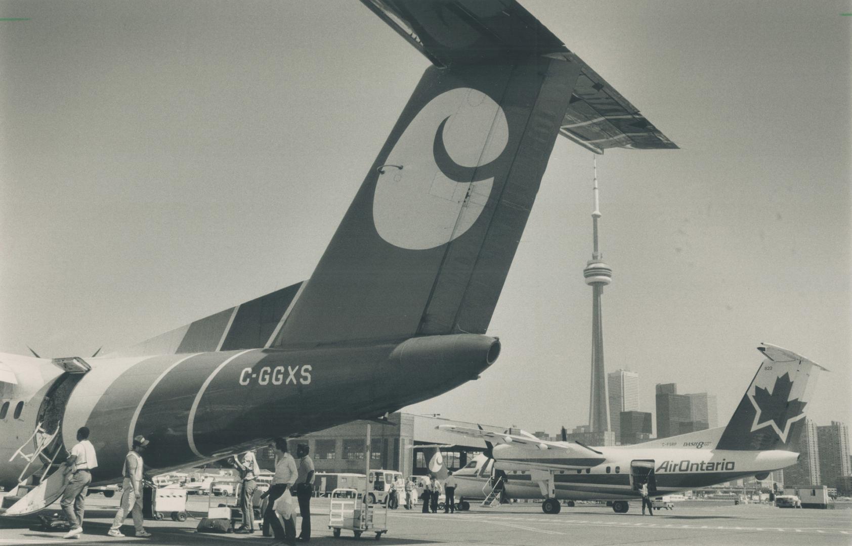 Flying low. City Express' Dash-7's are carrying the load after its Dash-8s, above, were seized by creditors. Air Ontario, which also flies to Montreal(...)
