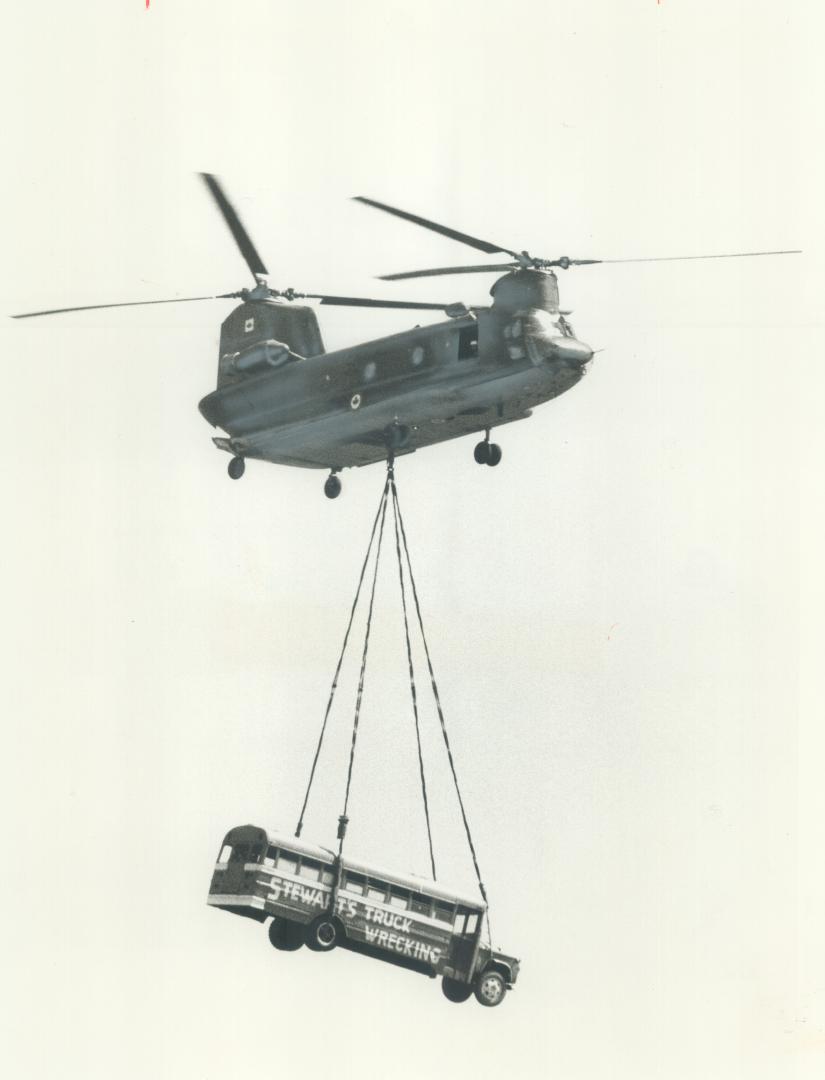 A Canadian forces helicopter shows its paces yesterday at the Canadian International Air Show at the CNE by lifting a full-size bus. The show, which o(...)