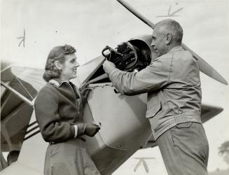 Former stunt-flier Fred Gillies of Toronto, and Marion, his daughter, with the cabin plane he presented to her this fall