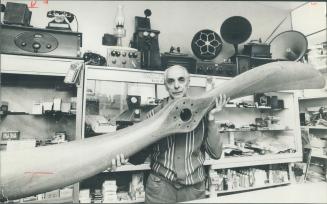 Wooden propeller dominates a collection of curiosities in the TV and variety store Charles Catalano owns on Gerrard St