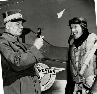 General W. Steffens, head of the Norwegian ministry of defence in Canada, examines the mascot of one of the Norwegian fliers in training. The plane, a(...)