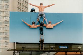 What goes up . . . A worker seems to shoulder a heavy load this week as he helps disassemble the three-dimensional Levi Strauss blue jeans billboard a(...)