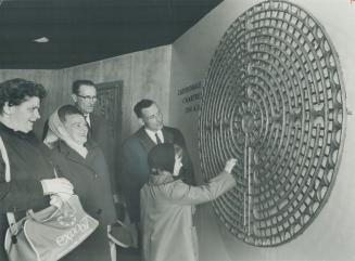 Ancient Egyptian Labyrinth on the wall of the National Film Board's Labyrinth pavilion at Expo attracts the attention of fair visitors. Inside the bui(...)