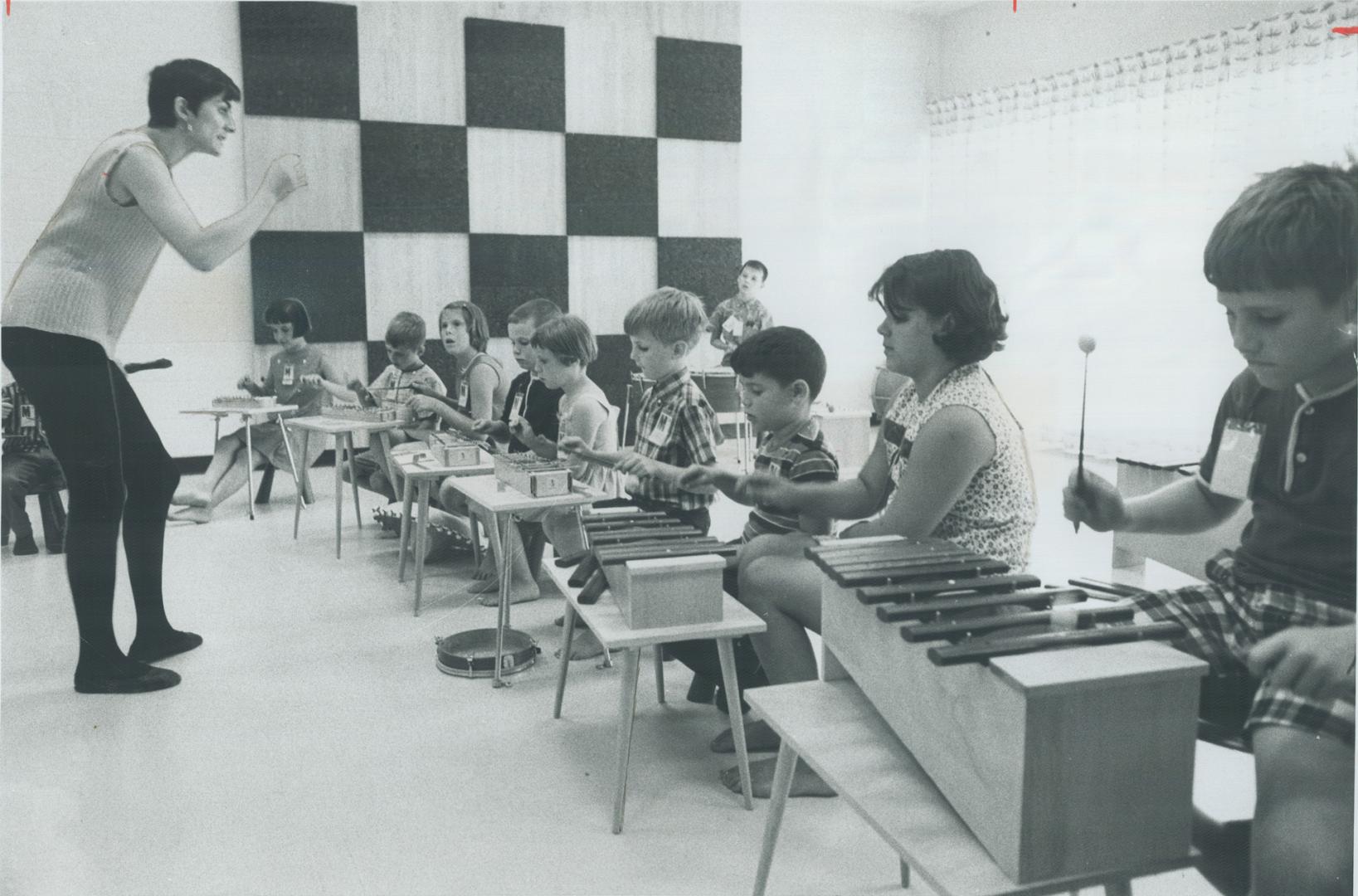 These children are fascinated by the music lesson which is part of their program at centre