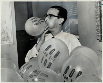 Blowup for Bob. John Boundy gives his all as he blows up balloons at campaign headquarters of Hon. Robert Macaulay, another of the leadership candidat(...)