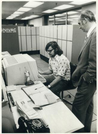 Alexander is also shown talking to computer technician Barry McCartney at main computer console