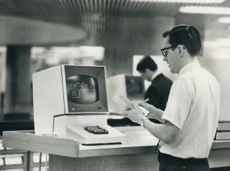 Frank booth checks the TV monitor connected to the city finance department computer