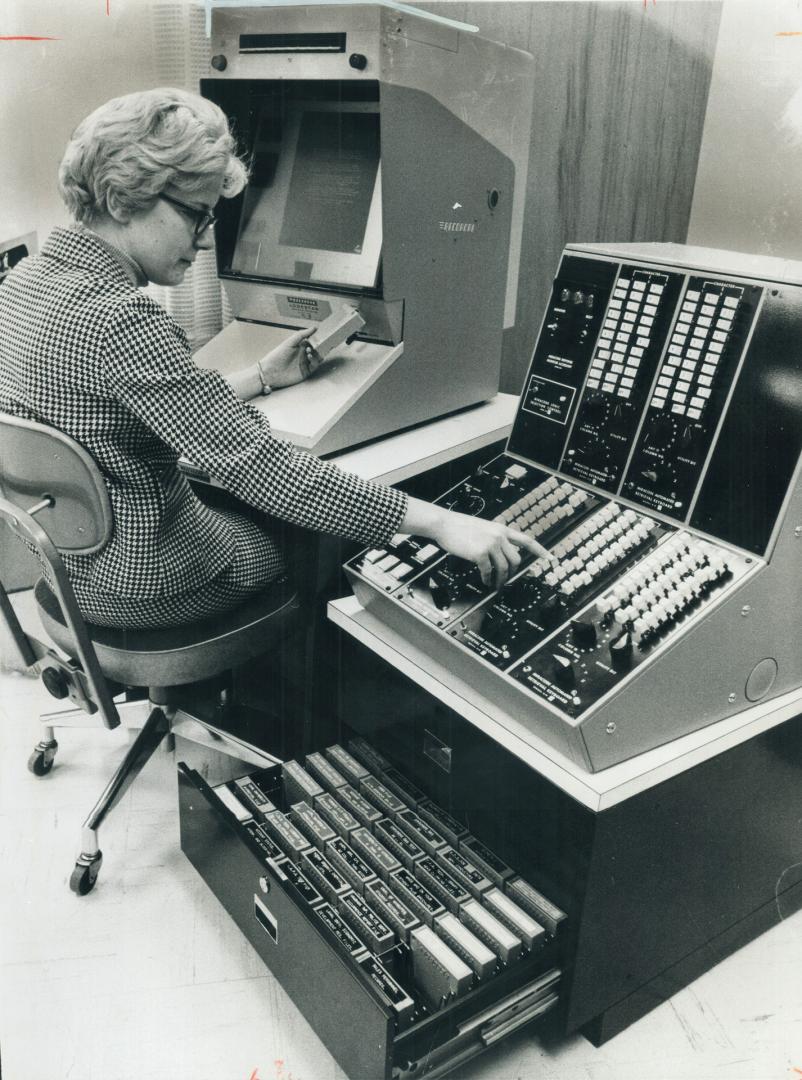 Lois Chipper operates a storage and retrieval system that in seconds will put on a screen a given page from one of 200,000 books