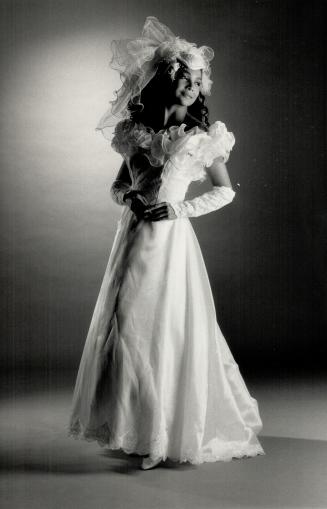 Ruffled organza: Right, wedding gown with lace gauntlets, $299, veil, $60 at Elizabeth Stuart Discount Bridal