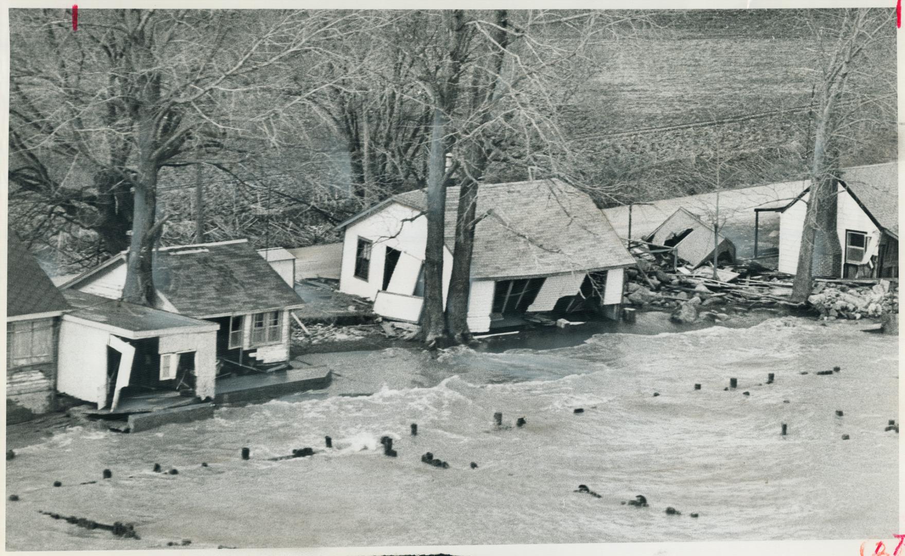 These cottages and Boathouses along the north shore of Lake Erie near Erieau, are among many which were badly damaged as a result of the recent storm. [Incomplete]