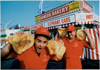 Dough boys: Shaun Fuller, left, and Fred Klemme lend an (elephant) ear outside their booth selling the deep-fried delicacy at the Ex
