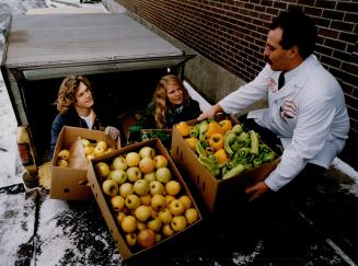 Sharing the wealth: Murray Russell and Sherllyn Kirkpatrick load truck with food Fortino's supermarket