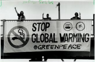 Strong message: Motorists on the Gardiner Expressway yesterday met up with this banner, hung by Greenpeace activicts to protest pollution from cars and mark the start of Bike to Work Week