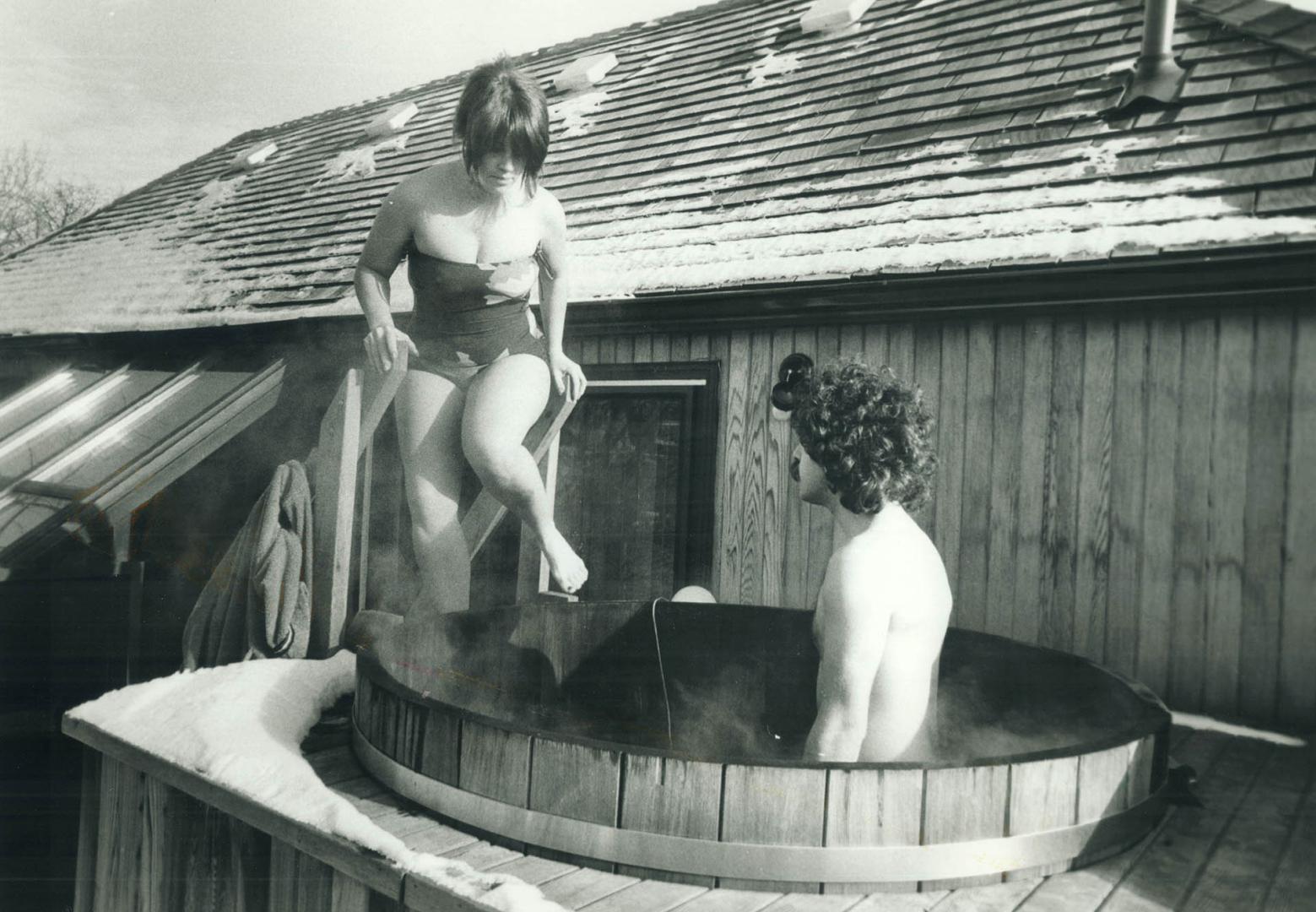 Warming up: Reporter Judy Nyman and Harley Mintz in their backyard (on the third floor) tub, enjoying the hot whirling water and keeping warm, while winter temperatures are grim