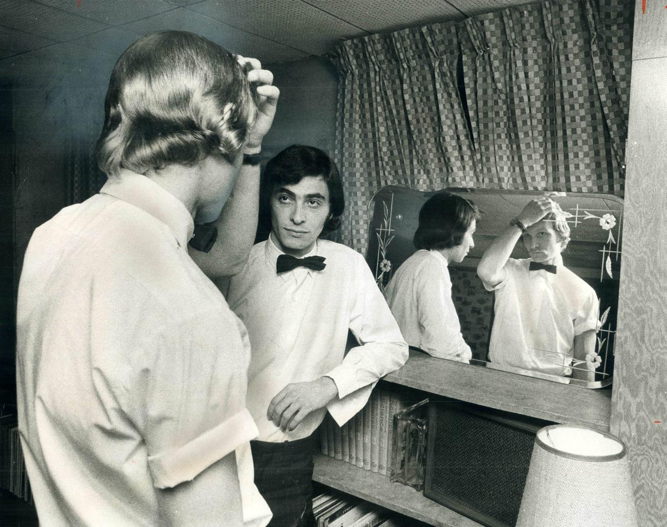 Suspended because of their long hair, two A and P employees, Bryan Hearst (left), 26, and Vito Cristello, 24, stand at a mirror discussing their pligh(...)