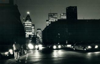 Blackout: Drivers and pedestrians made their way slowly and carefully along Front street wednesday night after a blackout plunged large areas of Toronto into darkness