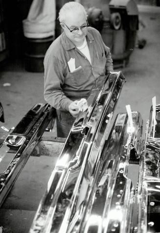 Like new: Tom Annand checks the gleaming bumpers as they come out of their chrome bath, just before they're carefully packed for shipping