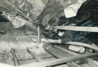 Cellulose fibre is blown into an attic to increase the insulation beyond the amount provided by the original fibre glass bats laid down when the house(...)