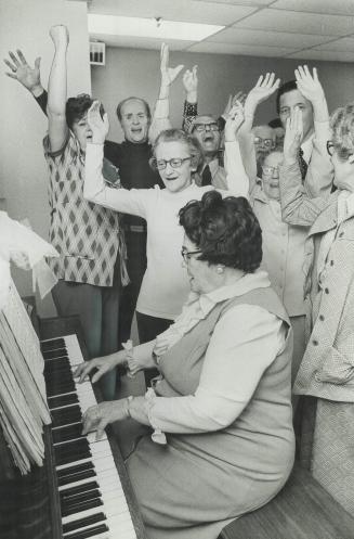 Lively music is pounded out on the piano by Rose Preece and participants in this Local Initiatives Program for lonely and disabled burst into song. Pr(...)