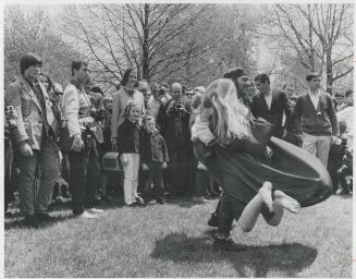 Round and round spins girl at yesterday's love-in, Harmless pranks like this amused 4,000 to 5,000 at Queen's Park